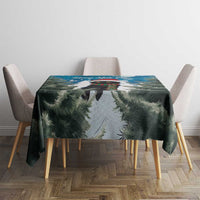 Blue Christmas tablecloth with fir branches and snow scene, centered on dining table