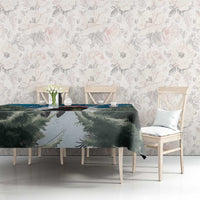 Blue-green Christmas tablecloth with fir branches print, draped across dining table