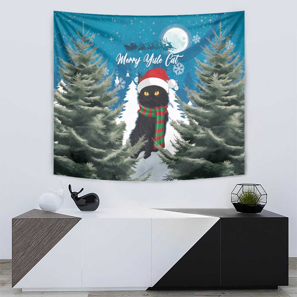 Blue tapestry showing cat in red hat and green plaid scarf with pine trees and snow path