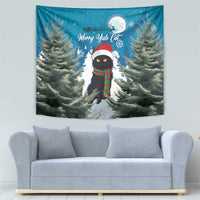 Blue wall tapestry featuring cat in red hat, green plaid scarf, and pine branches