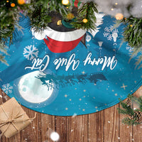 Blue Christmas tree skirt fabric close-up with moon, snowflakes, and cat graphic