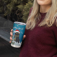 Blue tumbler cup with cat holiday graphic and silver lid, held near a person’s chest
