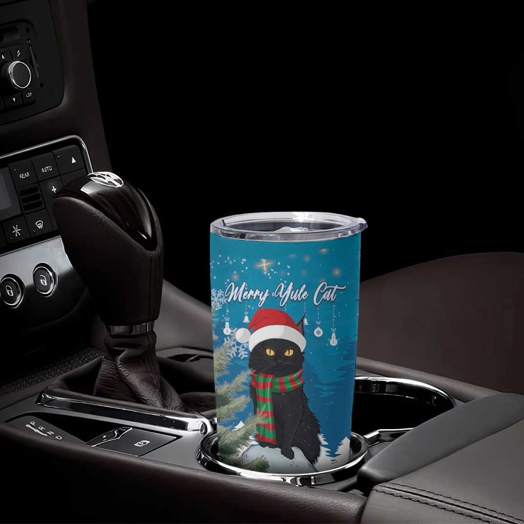 Blue Christmas cat tumbler cup with silver lid on center console, snowy forest graphic