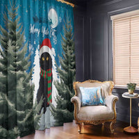 Blue window curtain panels featuring a black cat in Santa hat among pine trees