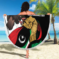 Round beach blanket laid out, black independence-themed eagle and lion graphic, white fringe