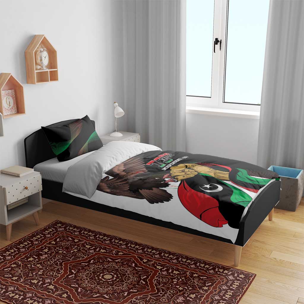 Bedding set on bed with black duvet and eagle graphic over Libyan flag; 73rd Independence Day