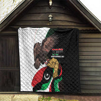 Black-and-white quilt with eagle and Libya flag design, "73rd Independence Day" logo