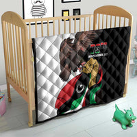 Black-and-white quilt on crib with eagle, Libya flag design, and "73rd Independence Day"