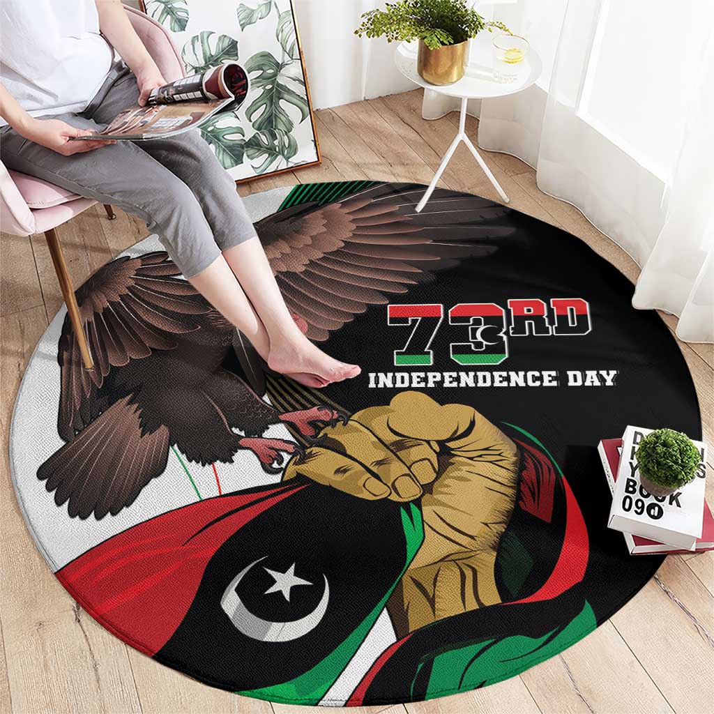 Black round printed carpet showing eagle, lion, and 73rd Independence Day artwork