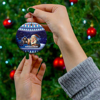 Blue circular ceramic Christmas ornament with gnome holding a bowl, hanging on gold cord