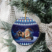 Blue circular ceramic ornament with gnome and house scene, hanging on gold cord