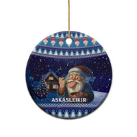 Blue circular ceramic ornament with gnome illustration and house scene, gold hanging loop