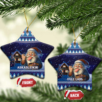 Pair of blue ceramic star ornaments with gnome illustrations, hanging on gold cords