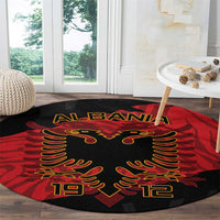 Albania independence day round carpet on wood floor, red-black with gold eagle details