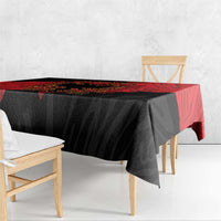 Black tablecloth with red side panel and eagle emblem, draped on wooden bench