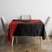 Black tablecloth with red eagle emblem panel, square table centerpiece