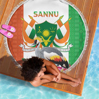 Round beach blanket with fringe edge, green and orange coat-of-arms kente crane graphic