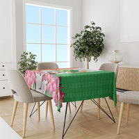 Green and pink floral tablecloth with geometric kente pattern along the table edge
