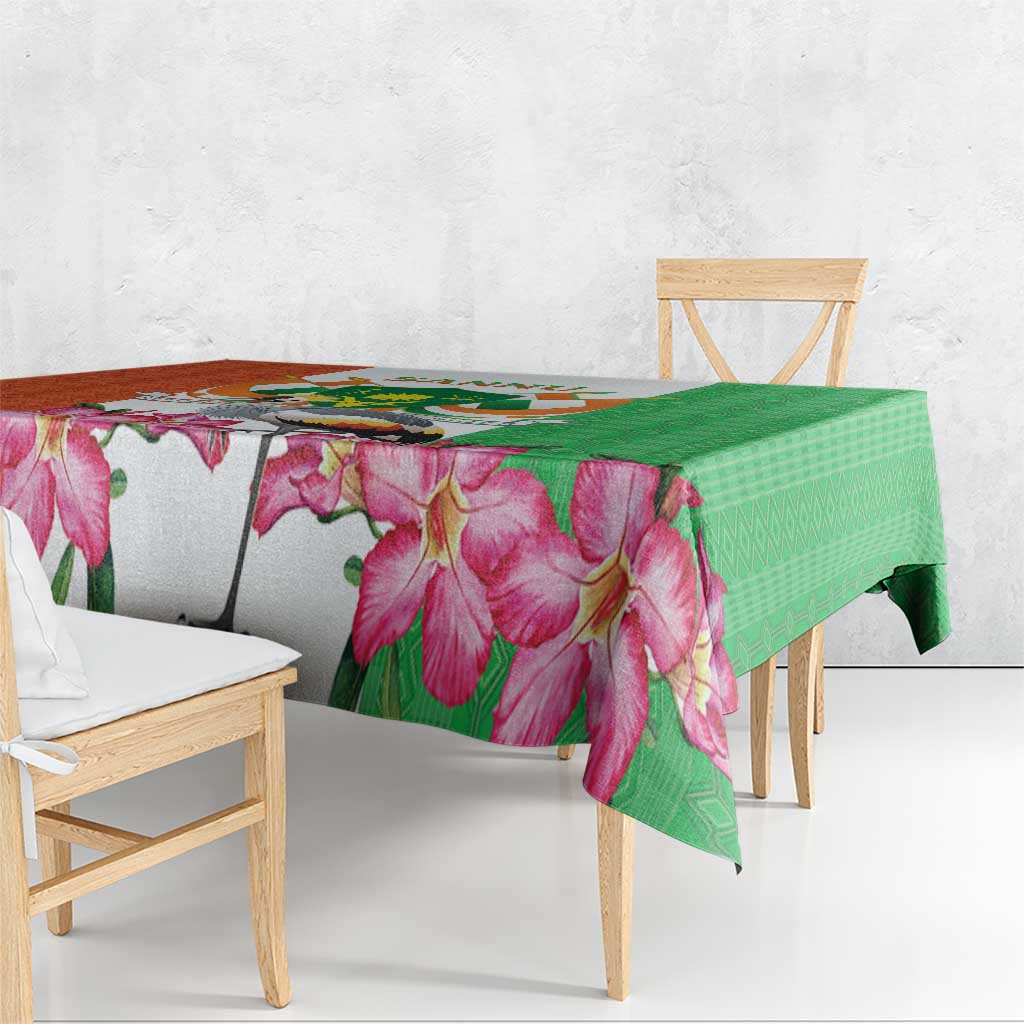 Green and pink floral tablecloth draped over table with geometric diamond pattern