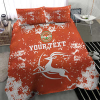 Orange bedding set with duvet and two pillows; white horse graphic, splatter print, emblem