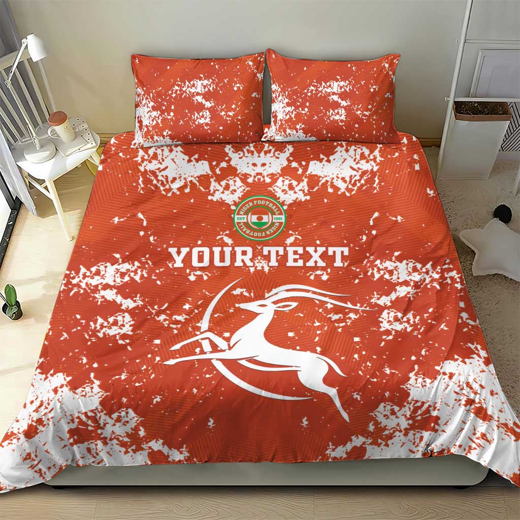 Orange duvet cover and two pillows with white splatter; 'YOURTEXT' and horse logo