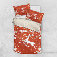 Orange duvet set with two standard pillows; white splatter print and 'YOURTEXT' text