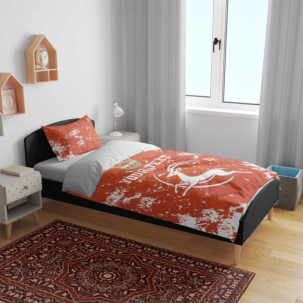 Orange graphic bedding set with duvet and two pillows; white horse and circular emblem