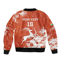Orange bomber jacket back with white jumping animal graphic, 'YOUR TEXT 15', and sleeve flag patch