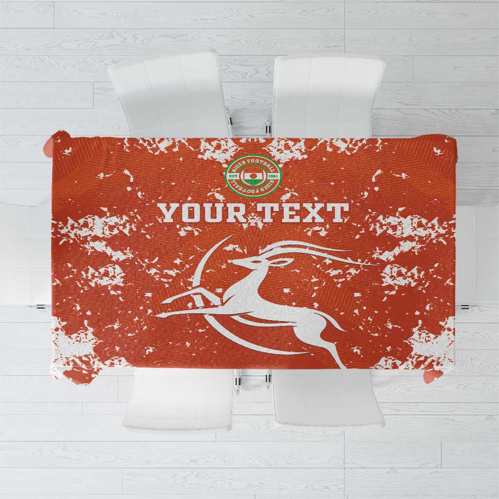 Orange football tablecloth with white splatter print and horse player graphic