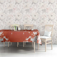 Orange football tablecloth with white splatter print on long dining table