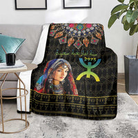 Black Berber pattern blanket on grey rug with woman portrait and gold decorative band