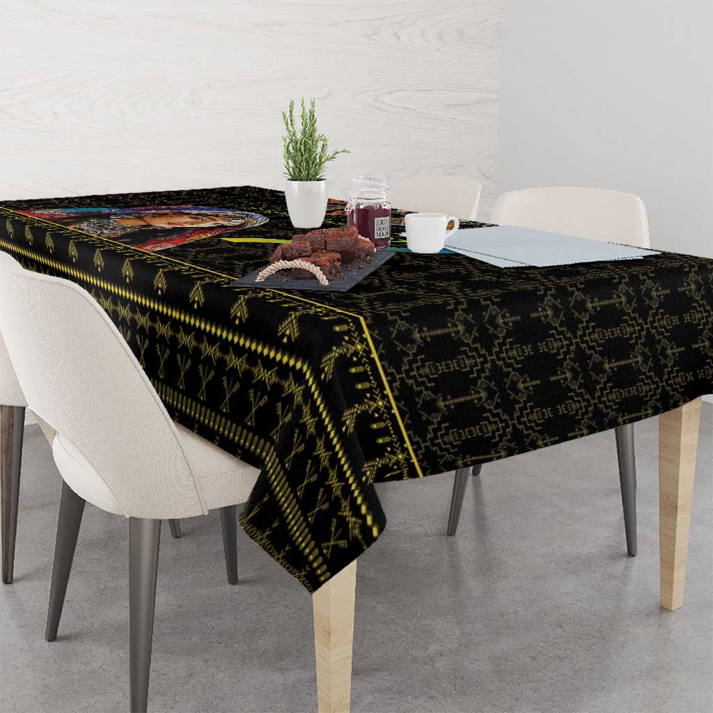 Black tablecloth with multicolor geometric border draped over dining table