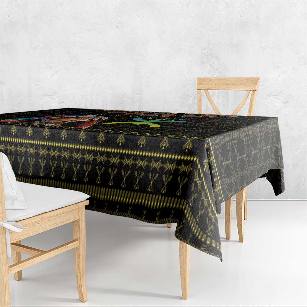 Black tablecloth with multicolor geometric pattern and gold trim on tabletop