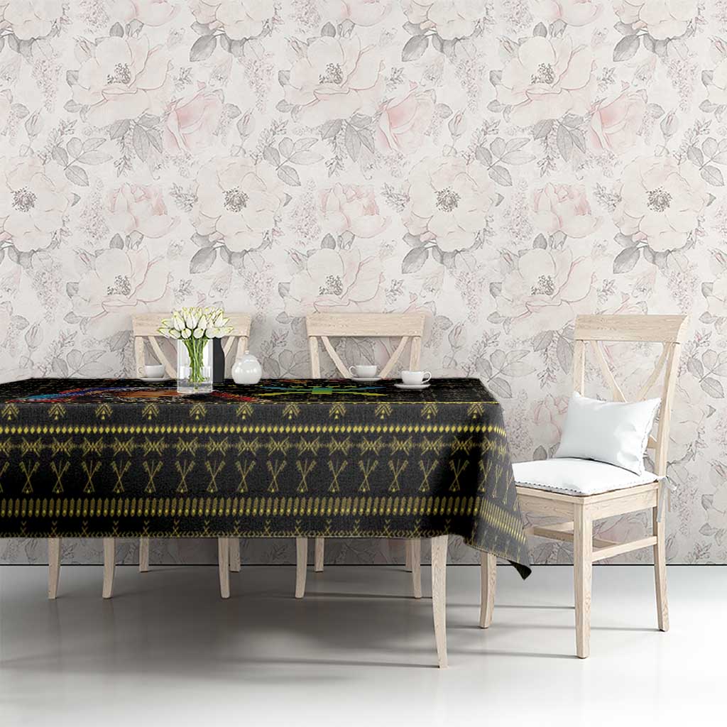 Black tablecloth with multicolor geometric Berber-style pattern across table