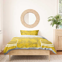 Yellow football bedding set on wooden bed: lion emblem duvet and two camo pillowcases