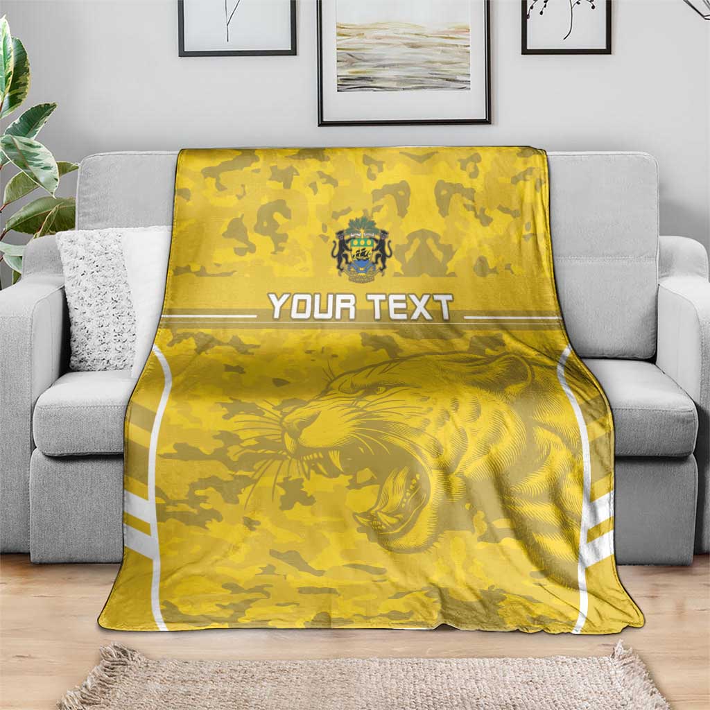 Custom yellow football blanket on gray couch with lion graphic and 'YOUR TEXT' band