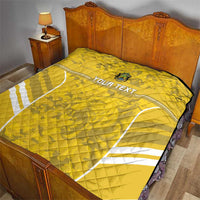 Yellow football quilt on bed with white field lines and custom text, quilted stitching detail