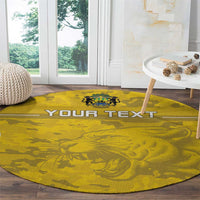 Round yellow football rug with 'YOUR TEXT' and lion crest on wood floor
