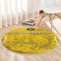 Round yellow football rug with 'YOUR TEXT' and lion crest beside white chair