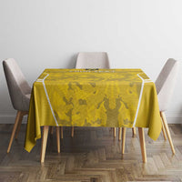Yellow football tablecloth with camo pattern and white edge stripes on dining table