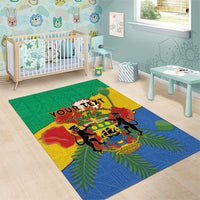 Green African-style area rug with colorful coat of arms and fern leaves in a room setting