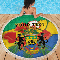 Round green beach blanket with fringe edge, draped on person, Gabon coat of arms and text