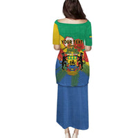 Personalized African print long dress, back view; green shoulder panel, blue skirt with lion emblem