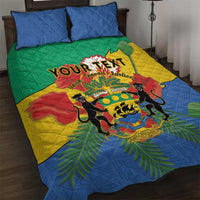 Green quilt bed set with lion crest and African pattern, with two blue pillows