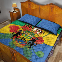 Quilt bed set with lion crest and tri-color African pattern, two blue pillows on bed