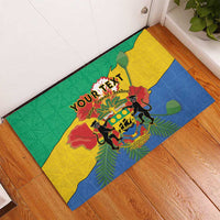 Corner view Gabon coat of arms rubber doormat, green yellow blue African pattern