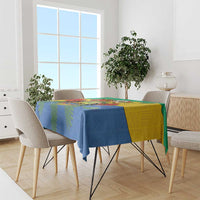 Gabon coat-of-arms tablecloth with African pattern, draped over dining table in blue and yellow
