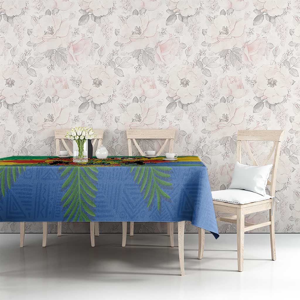 Gabon coat-of-arms tablecloth with African pattern on table, blue with green and yellow sections
