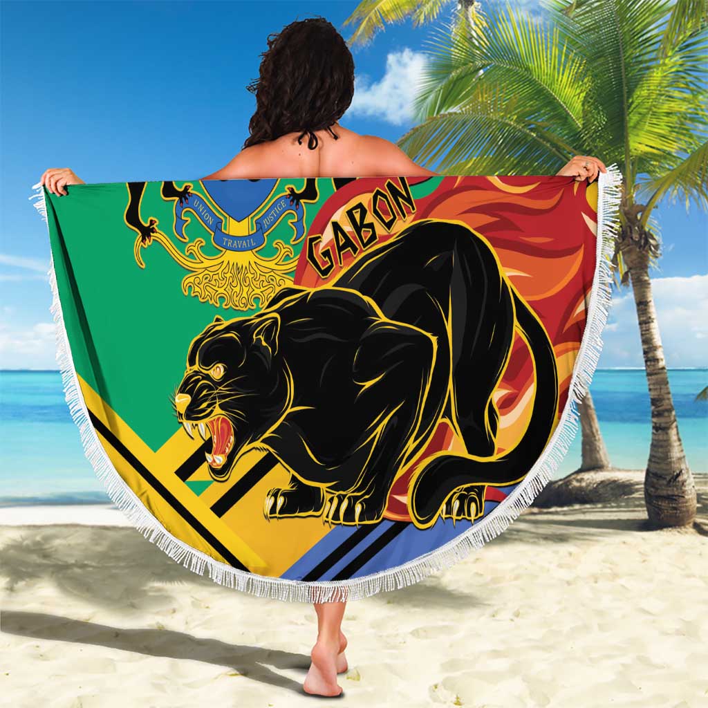 Green round beach blanket with white fringe, Gabon crest and black panther, beach sand shot