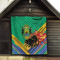 Green quilted blanket on wall backdrop with Gabon crest, black panther, flame stripes